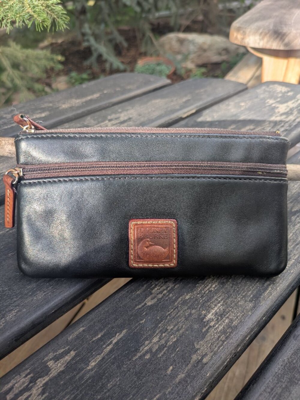 Dooney & Bourke Leather Double Zipper Pouch in black leather w/ duck logo.